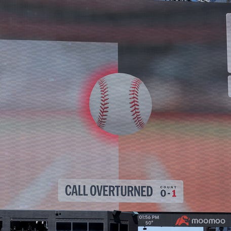 An overturned call displayed on the scoreboard at Citi Field.