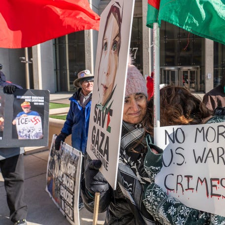 Heather Burnham, right, is comforted by Suhair Ghannam, center, while standing outside of the McNamara Federal Building in downtown Detroit on Tuesday, April 7, 2026, as a group of about fifty people gather to protest against U.S. military actions in the Middle East.