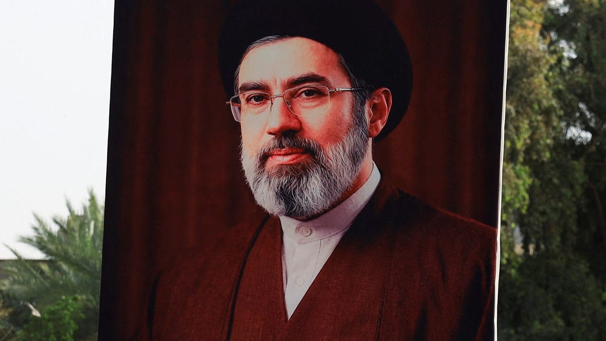 A man holds a poster of Iran's new Supreme Leader, Mojtaba Khamenei, during a solidarity rally in support of Iran and against Israel and the United States, amid heightened regional tensions due to the U.S.-Israel conflict with Iran, in Baghdad, Iraq, April 3, 2026. REUTERS/Thaier Al-Sudani