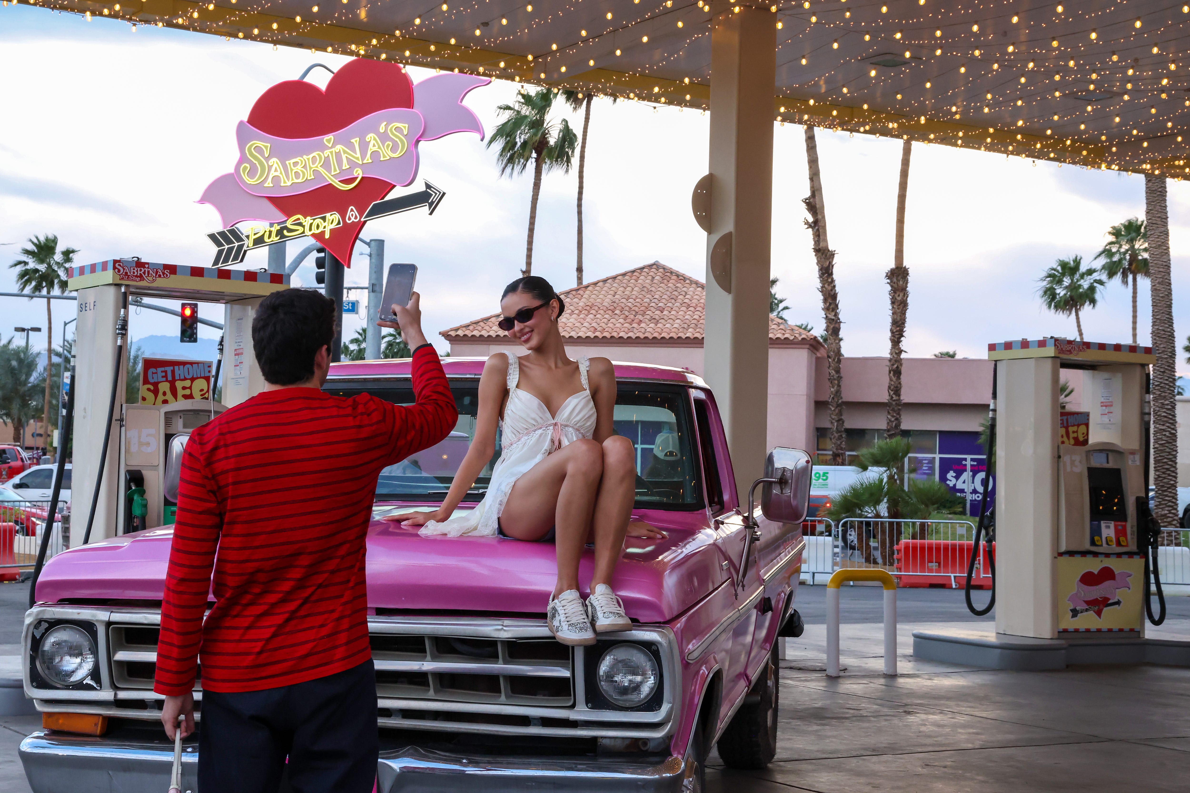 Beca Michie attends "Sabrina's Pit Stop" presented by Airbnb and Sabrina Carpenter, fans posed with vintage vehicles inspired by Sabrina’s universe.