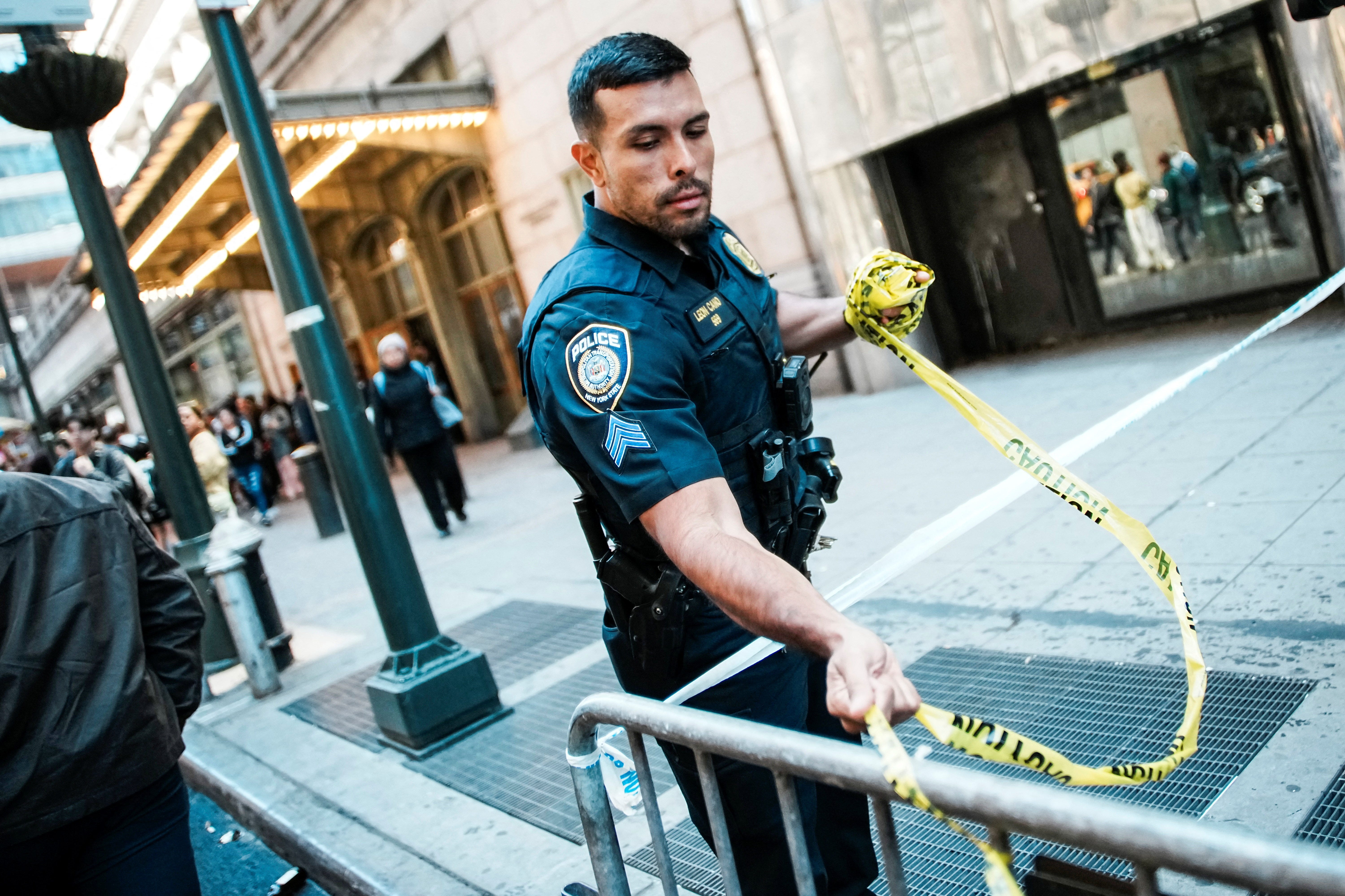A man wielding a machete stabbed three people on two New York City subway platforms before police fatally shot him on April 11, city officials said.