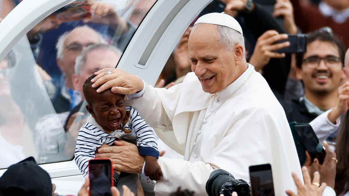 Pope Leo XIV blesses a child on the day of the Mass for the Jubilee of the Missionary World and Jubilee of Migrants in St. Peter's Square at the Vatican on Oct. 5, 2025.