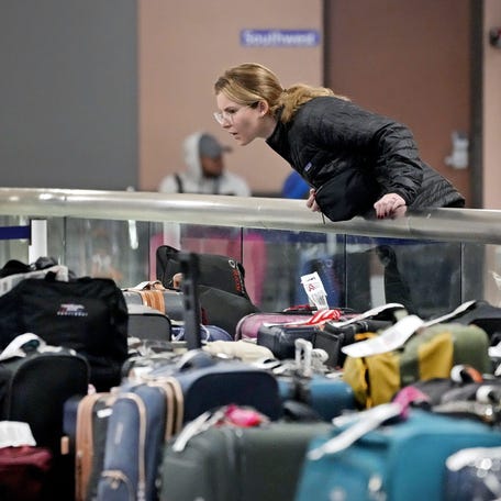 A Southwest Airlines employee unpacks luggage from an aircraft on the tarmac of the Jacksonville International Airport on Jan. 21, 2025.