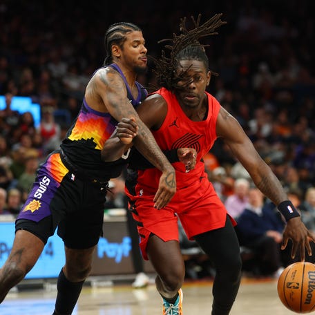 Portland Trail Blazers guard Jrue Holiday (5) drives to the basket against Phoenix Suns guard Jalen Green (4) during their game on Feb. 22, 2026.