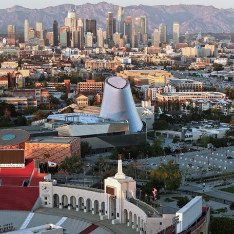 In an aerial view, Los Angeles Memorial Coliseum (BELOW) and the under-construction Samuel Oschin Air and Space Center (C) are shown in Exposition Park on March 5, 2026 in Los Angeles, California. Los Angeles Memorial Coliseum will host the LA Fan Festival during the World Cup and will host the Track and Field competitions and Opening Ceremony in the LA28 Summer Olympics.
