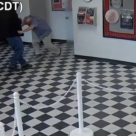 A screenshot from a surveillance video shows Pauls Valley principal tackling shooting suspect, stopping attack