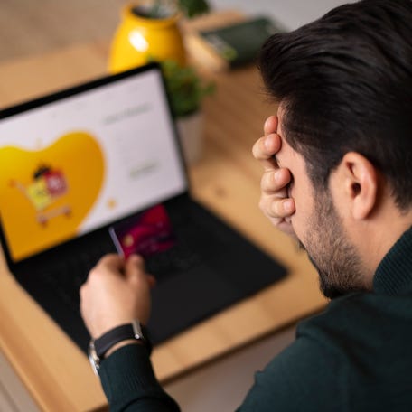 A photo illustration of a person with a problem with their credit card.