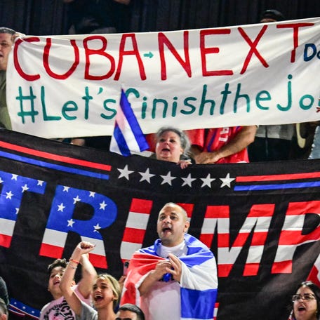 People hold Cuban flags and a flag supporting US President Donald Trump while participating in the "Cuba Libre" demonstration in the city of Hialeah, Florida, on March 24, 2026. (Photo by GIORGIO VIERA / AFP via Getty Images)