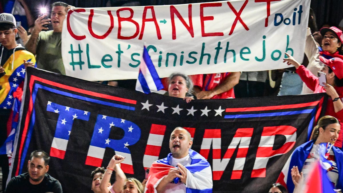 People hold Cuban flags and a flag supporting US President Donald Trump while participating in the "Cuba Libre" demonstration in the city of Hialeah, Florida, on March 24, 2026. (Photo by GIORGIO VIERA / AFP via Getty Images)