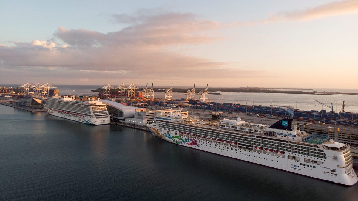 The Norwegian Pearl and the Norwegian Getaway cruise ships are seen docked in Miami, Florida on January 5, 2022.