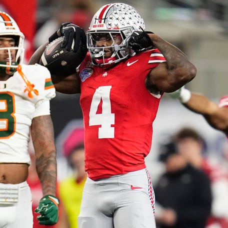 Ohio State wide receiver Jeremiah Smith (4) celebrates a first down against Miami (Fla.) during the 2025 Cotton Bowl at AT&T Stadium2in Arlington, Texas.