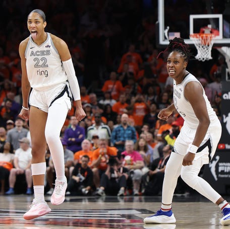 PHOENIX, ARIZONA - OCTOBER 08: A'ja Wilson #22 of the Las Vegas Aces reacts with Chelsea Gray #12 after her made basket against the Phoenix Mercury with less than one second left in the fourth quarter of Game Three of the 2025 WNBA Playoffs finals at Mortgage Matchup Center on October 08, 2025 in Phoenix, Arizona. (Photo by Christian Petersen/Getty Images)