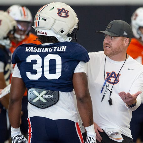 Auburn Tigers head coach Alex Golesh talks with Auburn Tigers running back Bryson Washington (30) during practice at Woltosz Football Performance Center in Auburn, Ala. on Thursday, April 16, 2026.