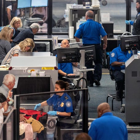 TSA agents work to get passengers through security at Palm Beach International Airport on April 1, 2026, in West Palm Beach, Florida.