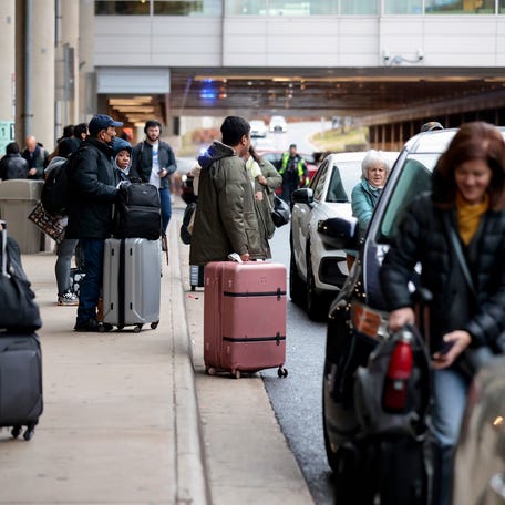 Travelers crowd Ronald Reagan Washington National Airport on Dec. 23, 2025 in Arlington, Virginia.