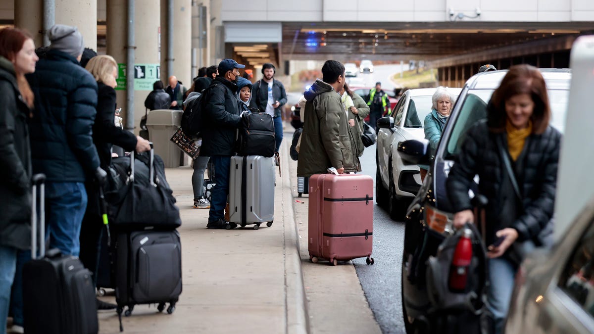 Travelers crowd Ronald Reagan Washington National Airport on Dec. 23, 2025 in Arlington, Virginia.