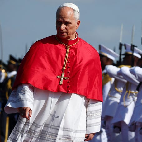 Pope Leo XIV walks after arriving at Quatro de Fevereiro International Airport to begin his apostolic journey to Angola, in Luanda, Angola, April 18, 2026.
