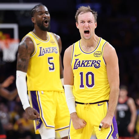 Deandre Ayton #5 and Luke Kennard #10 of the Los Angeles Lakers react after a 3-point shot during the second half against the Houston Rockets.