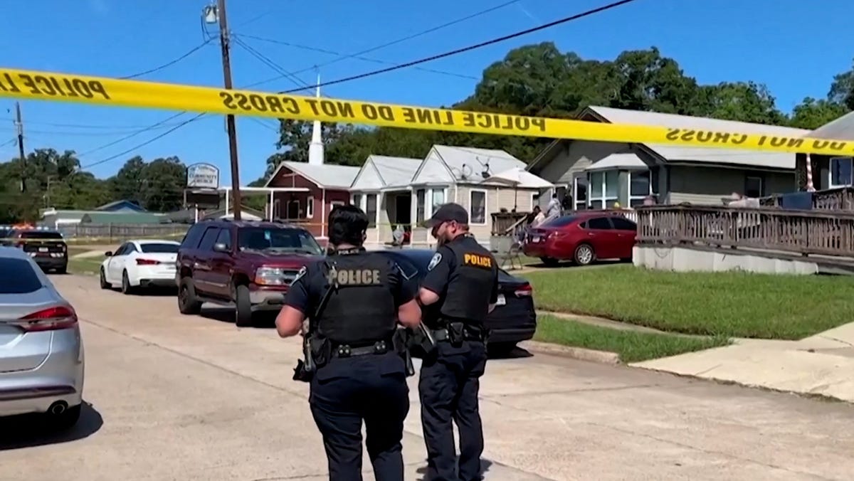Police officers secure a street where eight children, with ages ranging from 1 to 14, were killed in a mass shooting in Shreveport, La. on April 19, 2026, in a still image from video.
