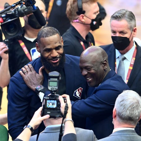 Michael Jordan and LeBron James hug after the presentation of the NBA 75th Anniversary Team during the 2022 NBA All-Star Game at Rocket Mortgage Fieldhouse on February 20, 2022 in Cleveland, Ohio.