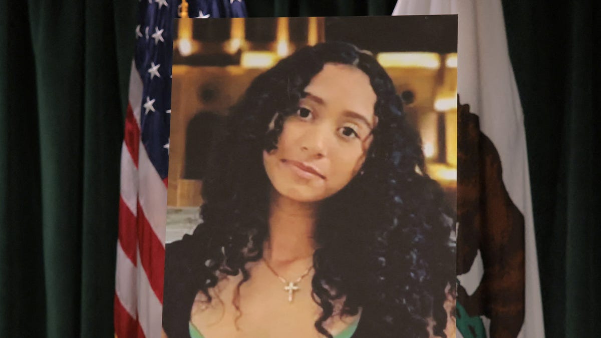A picture of Celeste Rivas Hernandez, whose body was found in the front trunk of a Tesla registered to the musician D4vd on Sept. 8, 2025, is displayed during an April 20, 2026, Los Angeles County District Attorney's Office press conference. Days earlier, the 21-year-old singer, whose real name is David Anthony Burke, was arrested on suspicion of her murder.
