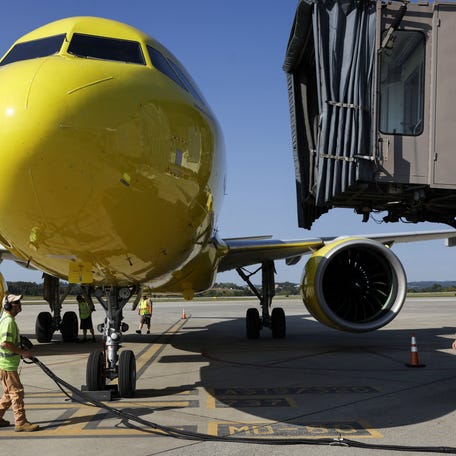 Airport employees work on the tarmac as a Spirit Airlines flight arrives at Arnold Palmer Regional Airport in Westmoreland County, Pennsylvania, U.S., September 18, 2025.