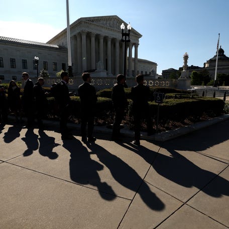 Visitors wait for the U.S. Supreme Court to open in Washington, DC, April 20, 2026.