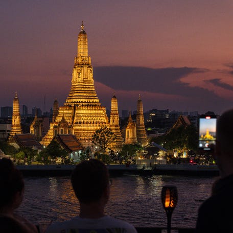 The Wat Arun Buddhist temple is pictured illuminated before its lights are turned off to mark the Earth Hour in Bangkok on March 28, 2026. (Photo by chanakarn LAOSARAKHAM / AFP via Getty Images)