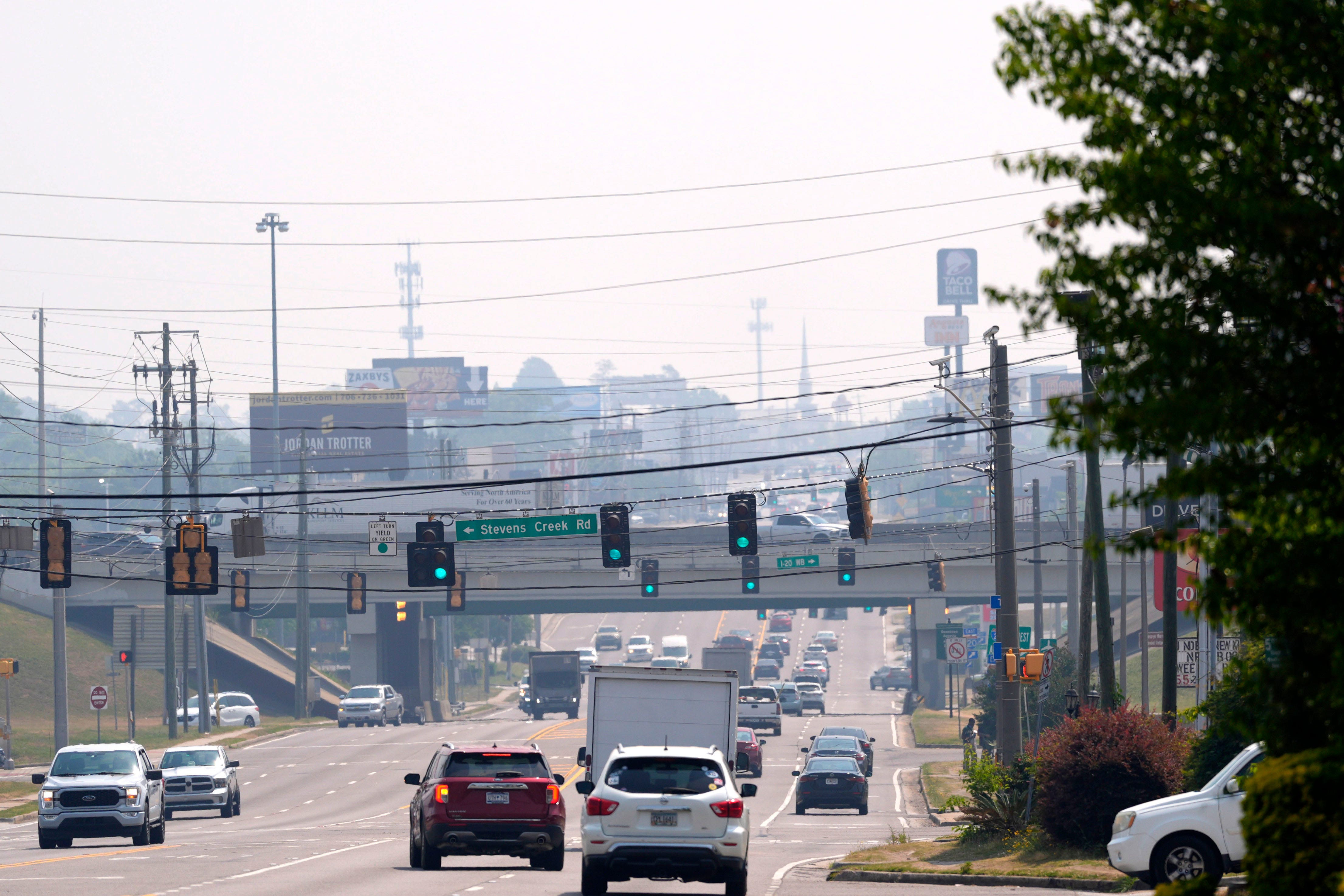 Wildfires fueled by extreme drought are burning across Georgia and Florida, prompting burn bans and road closures.