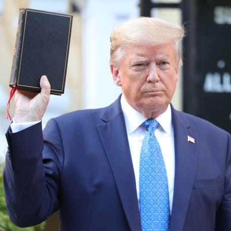 President Donald Trump holds up a Bible as he stands in front of St. John's Episcopal Church across from the White House on June 1, 2020.