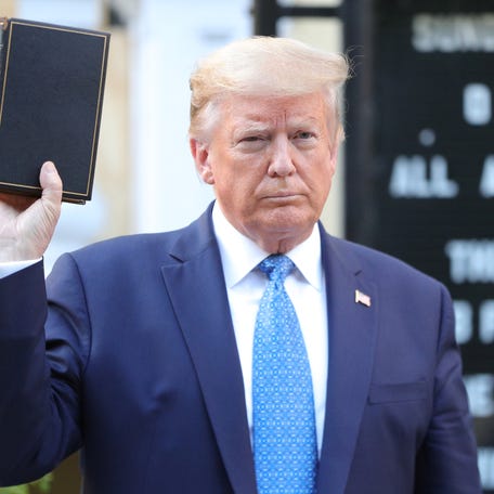Donald Trump holds up a Bible as he stands in front of St. John's Episcopal Church across from the White House on June 1, 2020.