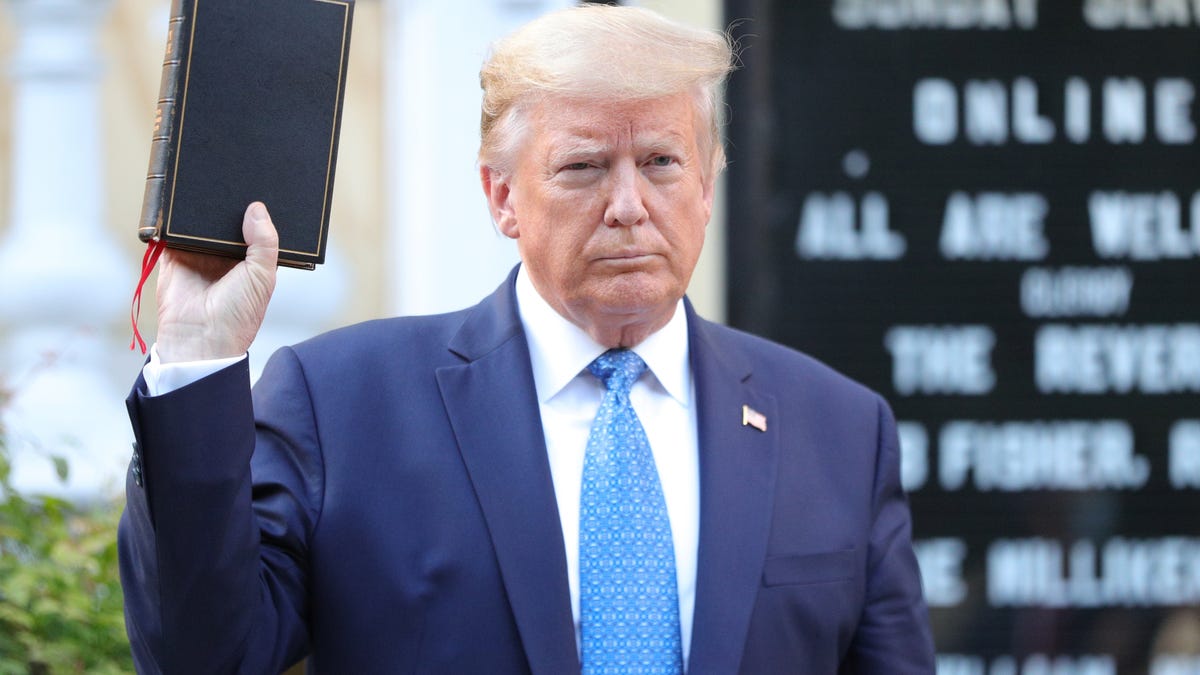 Donald Trump holds up a Bible as he stands in front of St. John's Episcopal Church across from the White House on June 1, 2020.