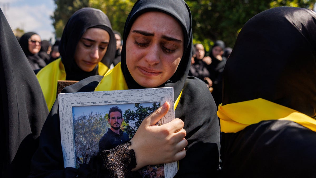A woman mourns her relative Ali Ballout, a civil defence member killed during the conflict with Israel and exhumed from a temporary grave, during his funeral in his home village, amid a 10-day ceasefire between Lebanon and Israel, in Aitit village, southern Lebanon, April 22, 2026.