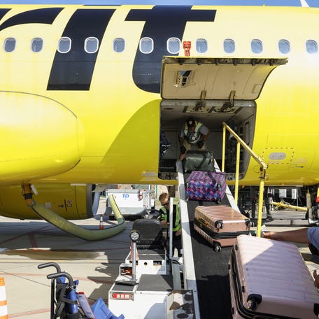 Airport employees unload luggage on the tarmac as a Spirit Airlines flight arrives in Westmoreland County, Pennsylvania, on Sept. 18, 2025.