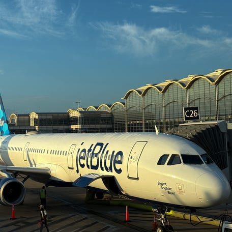 A JetBlue Airways passenger plane is parked at a gate at Ronald Reagan Washington National Airport on August 24, 2025, in Arlington, Virginia. (Photo by Daniel SLIM / AFP) (Photo by DANIEL SLIM/AFP via Getty Images)