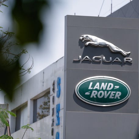 Jaguar and Land Rover, the British vehicle-brand logos of Indian-owned Tata Motors, are displayed in front of their showroom in New Delhi, India, April 2, 2025.