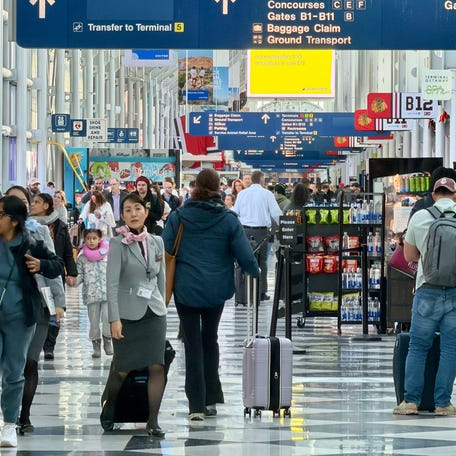 Air travelers walk on a concourse at Chicago O'Hare International Airport in Chicago on Jan. 15, 2026.