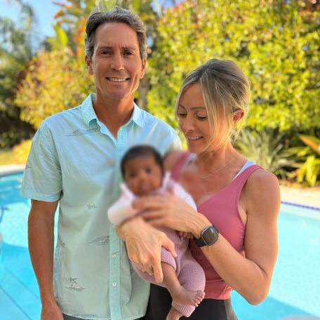 A photo of Tiffany Score and Steven Mills with their baby. The baby's face was blurred by the family's lawyer.