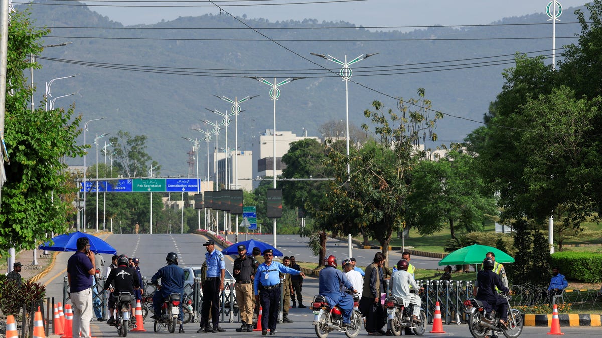 Police officers divert traffic on road leading to Serena Hotel, as Pakistan prepares to host the U.S. and Iran for the second phase of peace talks in Islamabad, Pakistan, April 23, 2026.