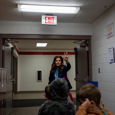 Julissa Garcia Milukhin, a lead Great Start Readiness Program teacher, leads children down a hallway during a class at the Early Impressions Vandercook Lake program inside Townsend Elementary School in Jackson, Michigan on April 21, 2026.