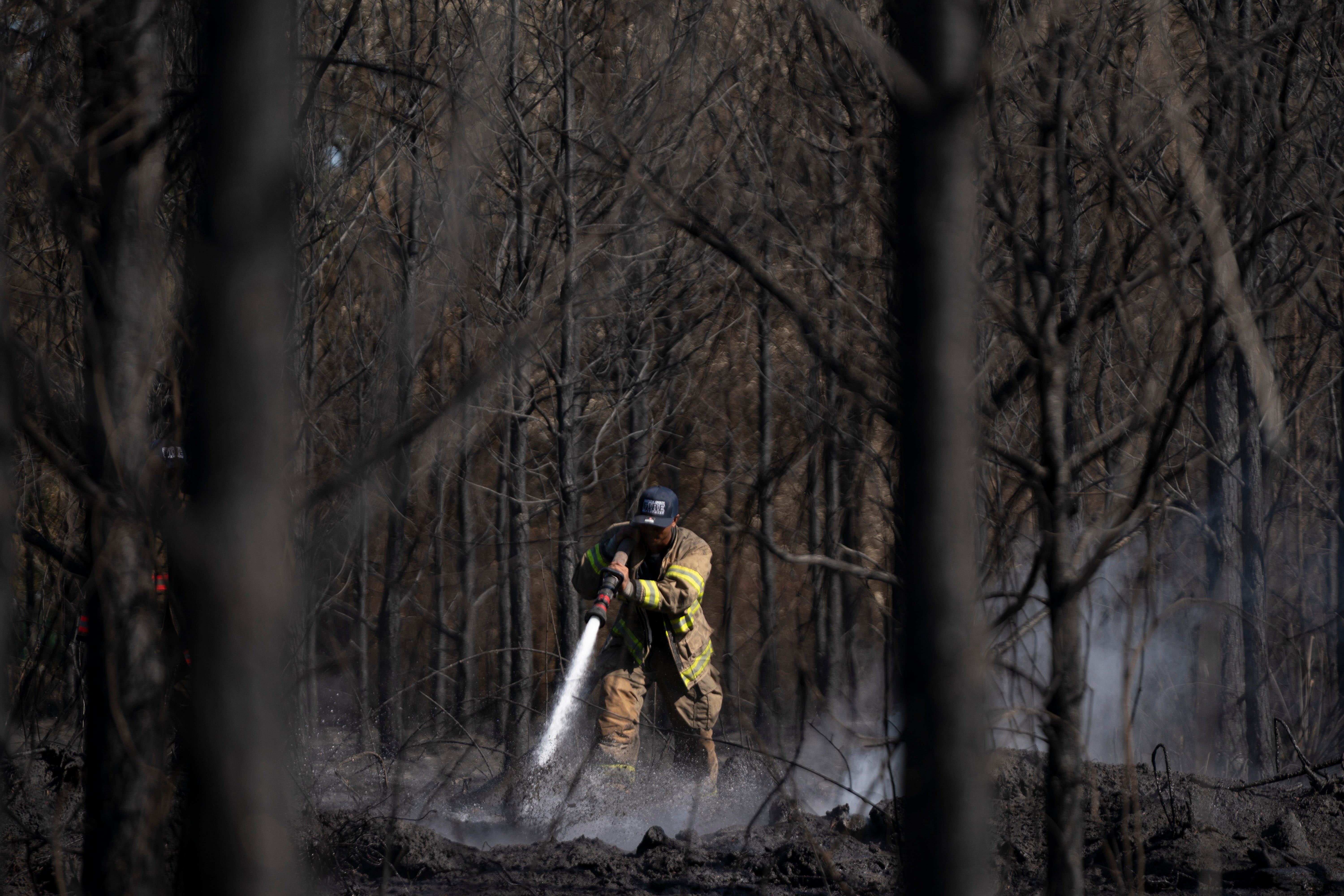 Two of the fires have led to unprecedented losses of homes, with dozens destroyed and more in danger, Gov. Brian Kemp said.