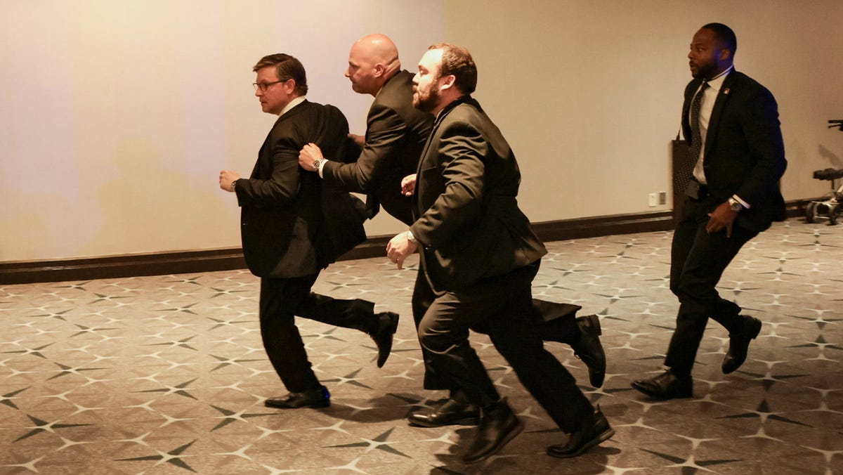 Security officials evacuate U.S. House Speaker Mike Johnson (R-LA) as a shooter opens fire during the annual White House Correspondents' Association dinner in Washington, D.C., U.S., April 25, 2026.