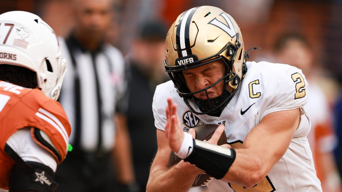 Diego Pavia #2 of the Vanderbilt Commodores is tackled by Xavier Filsaime #17 of the Texas Longhorns during the game at Darrell K Royal-Texas Memorial Stadium on November 01, 2025 in Austin, Texas.