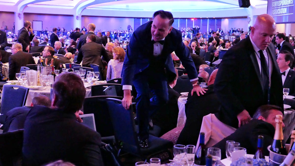 Dan Scavino jumps over a chair after an incident at the annual White House Correspondents Association Dinner.