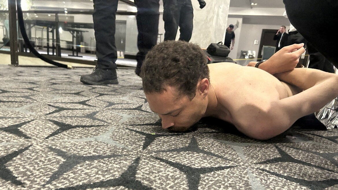 Law enforcement personnel detain Cole Tomas Allen, a suspect in the shooting incident at the White House Correspondents' Association dinner, in Washington, D.C., U.S. April 25, 2026.