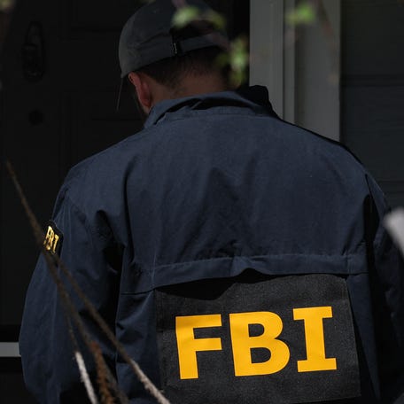 Members of the FBI knock on the doors of neighbors of a home associated with the White House Correspondents' Dinner shooting suspect in Torrance, California, on April 26, 2026.