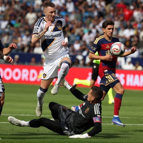 April 26: The LA Galaxy's Marco Reus (18) jumps over Real Salt Lake goalkeeper Rafael Cabral during the first half at Dignity Health Sports Park in Carson, California. Reus scored two goals as the Galaxy won the match, 2-1.
