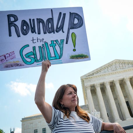 Protestors gather outside the Supreme Court as the justices hear arguments in Monsanto Company v. Durnell, on April 27, 2026, in Washington, DC.