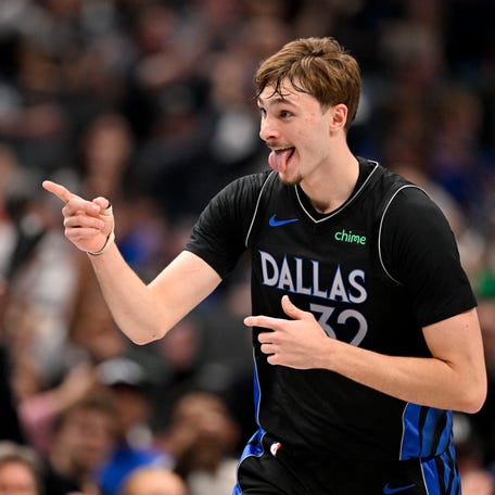 Dallas Mavericks forward Cooper Flagg points to his team bench as he celebrates scoring against the Denver Nuggets during the second quarter at the American Airlines Center on Dec. 23, 2025.