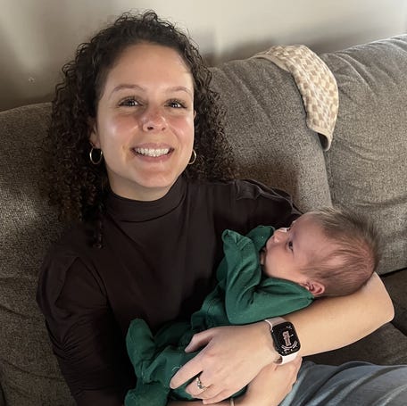 Women and the Caregiving Economy Reporter Madeline Mitchell holding her childhood friend Ariana Georganas' son, Callahan.